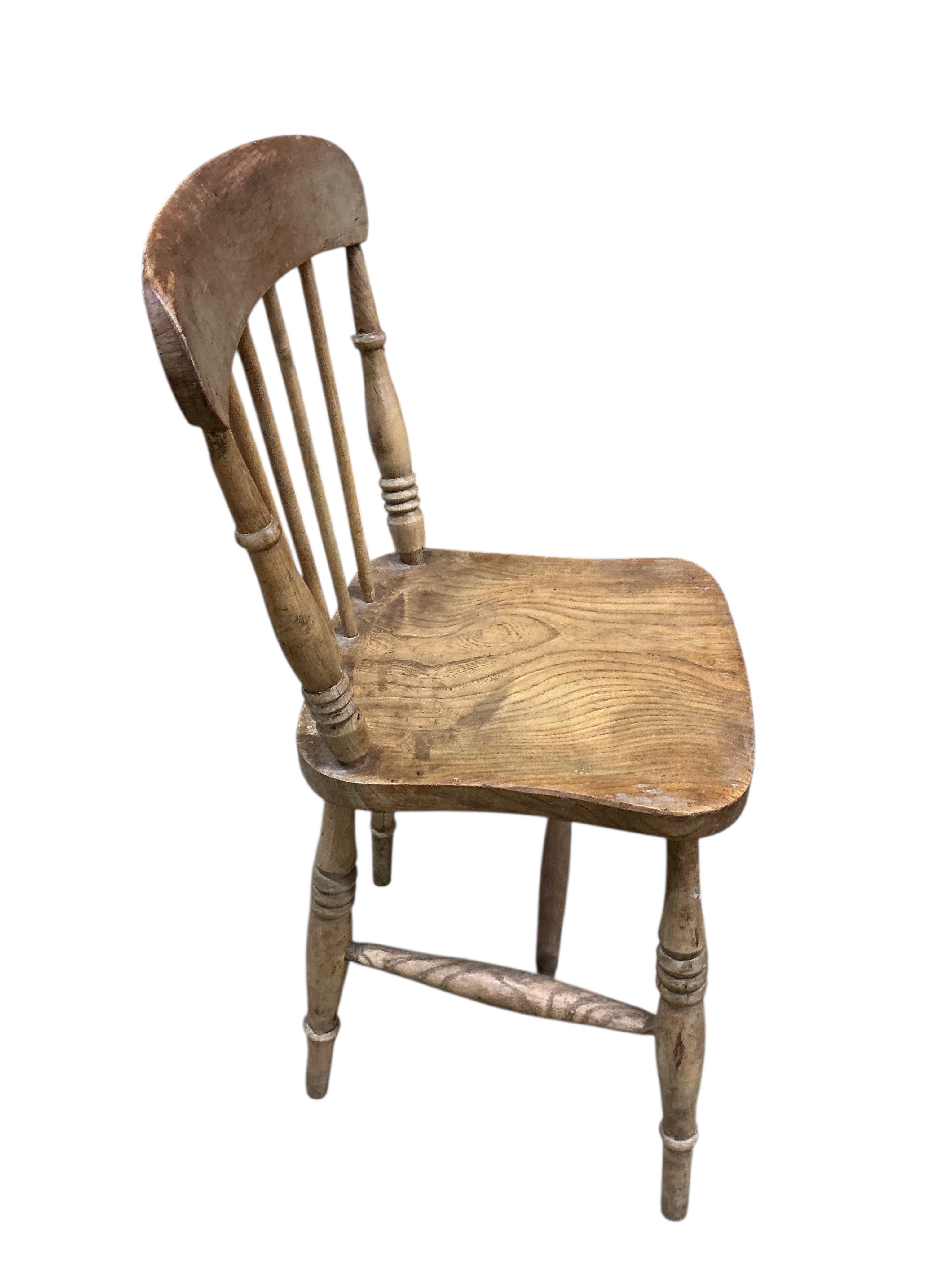 A Victorian rectangular pine kitchen table, width 133cm, depth 82cm, height 72cm together with four Victorian Windsor elm and beech comb back kitchen chairs